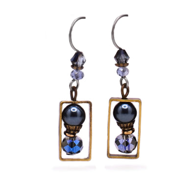 These gemstone earrings feature a circular hematine bead with brass accents and a light blue faceted glass underneath all encased in a rectangular brass accent. Above the rectangle is another glass bead and an Austrian crystal bead.