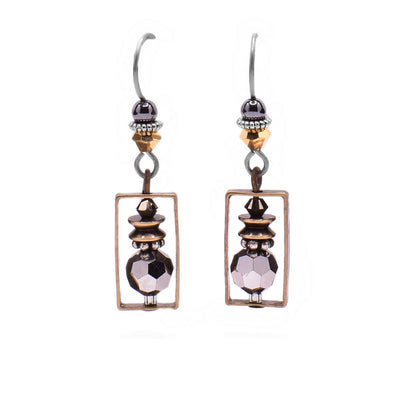 These dainty earrings feature a rectangular brass accent in which there is a grey Austrian crystal with brass and silver accents. Above is a yellow crystal with a hematine bead.