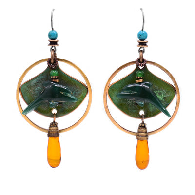 These dolphin earrings feature an abstract shape copper piece with a green side-profile of a dolphin attached at the front and a small aventurine bead on top. Around the copper is a circular brass accent to which a teardrop Baltic amber is attached at the bottom.