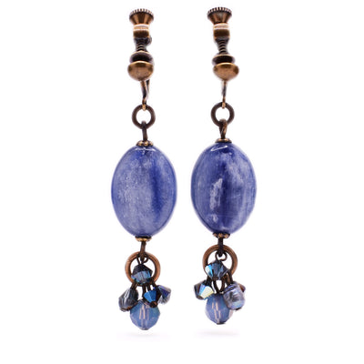 These clip earrings feature an oval, blue kyanite in the center with a cluster of dark and light blue gemstones attached at the bottom.