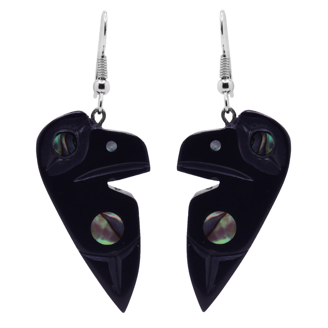 These argillite stone and abalone earrings have chunky argillite hangs that have been carved to depict the Raven. The Ravens head is by the hangs and is has a wing depicted below it. There is abalone set by the wing and in the eye. 