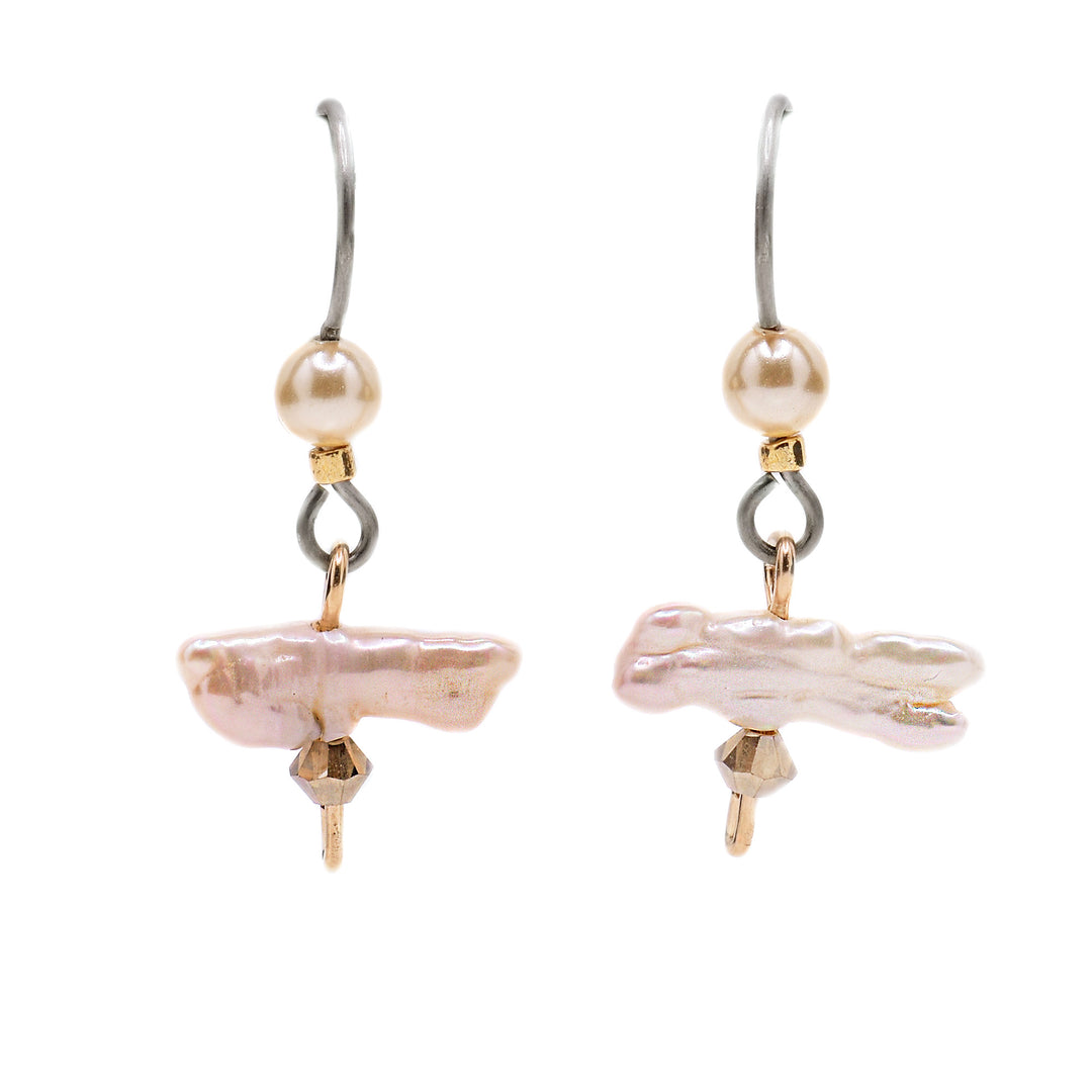 These dainty pearl earrings feature abstract-shaped, white pearls as the centerpiece with a small, yellow crystal underneath and gold-filled wire accents. There is a white crystal pearl above.