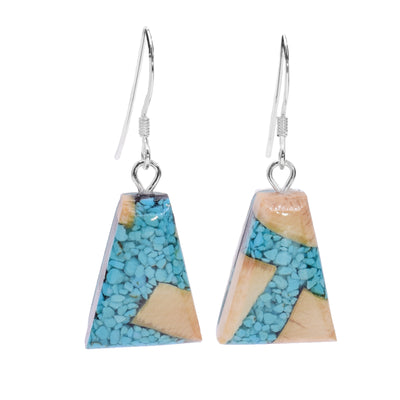 These dangling turquoise earrings are made from fossilized mammoth ivory and turquoise gemstone. The hangs are trapezoids and have pieces of the turquoise and chunks of the ivory set into resin.