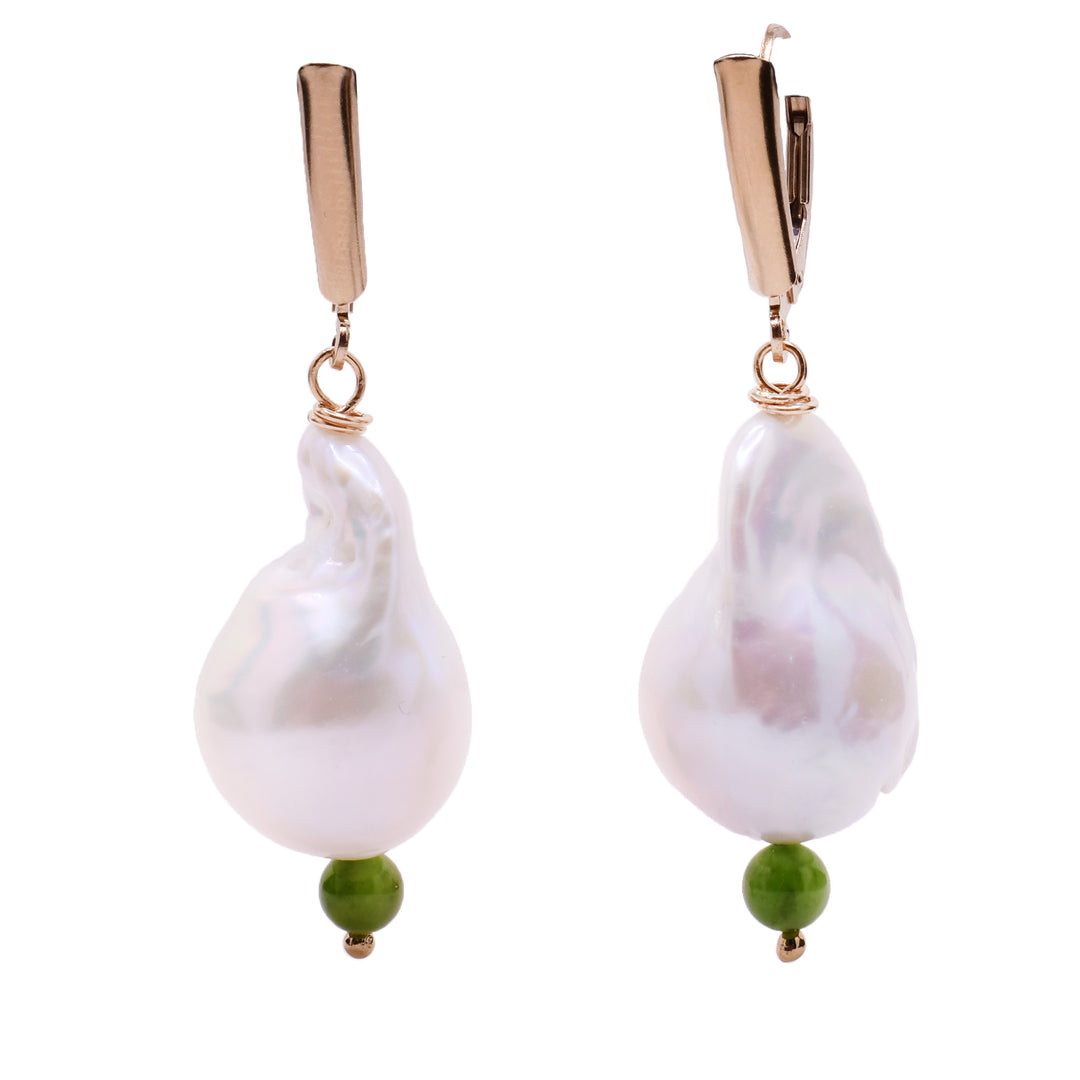 These baroque pearl earrings feature a large, white pearl as the centerpiece with a small green jade bead attached at the bottom. On top are gold-filled accents and a gold-filled clasp.