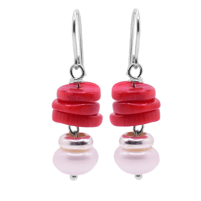 These pearl earrings dangle have round, flat red bamboo coral beads stacked on top of each other with a sterling silver and below and freshwater pearls at the bottom. The coral are grouped together and the silver and pearls dangle below them. 