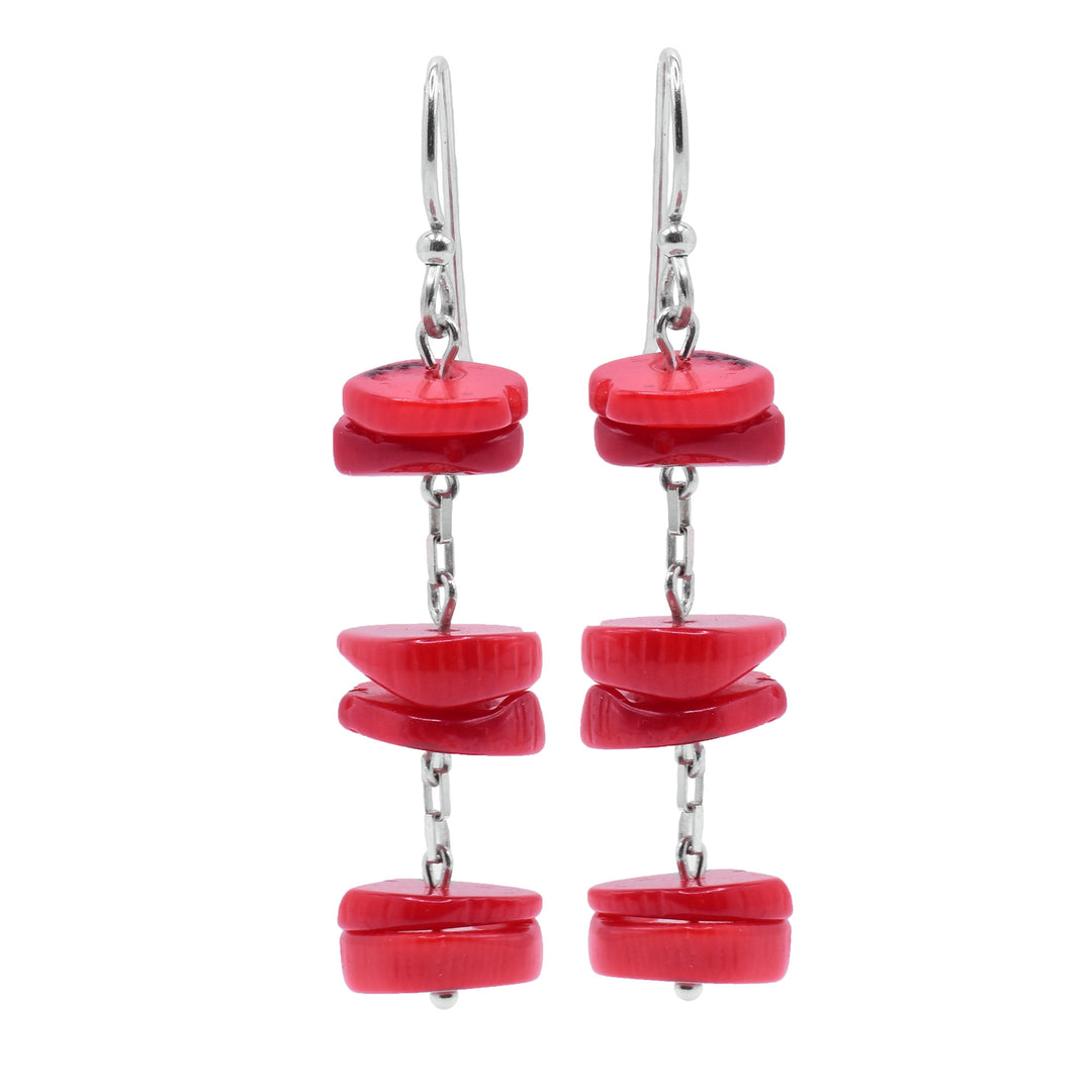 These red coral earrings are made of three sections of flat, round beads made from red bamboo coral. On each earrings, there are three groups of two pieces of coral which hang from and are separated by small, sterling silver chains.