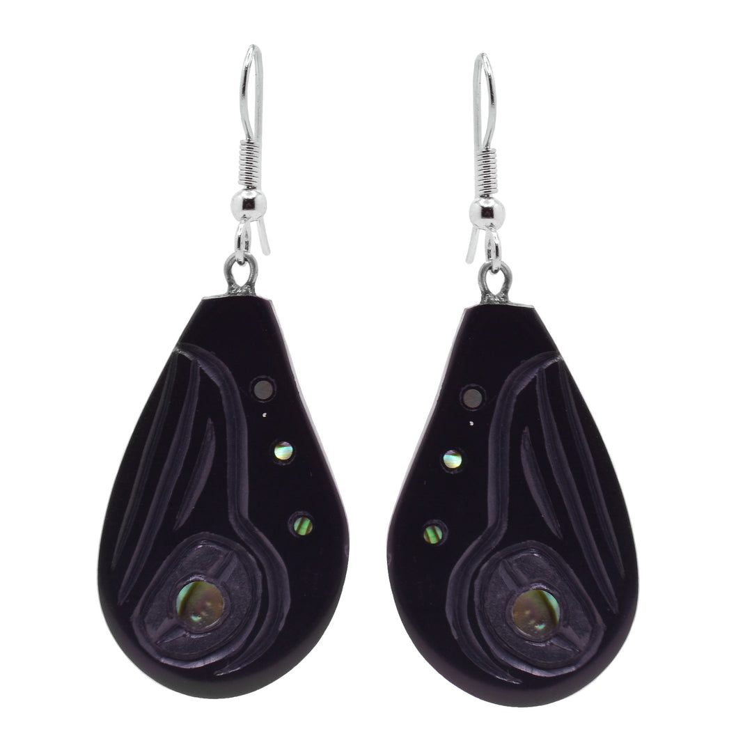 These large teardrop earrings have hangs made from argillite stone that have a teardrop shape to them. The head of the Hummingbird is carved into them at a side profile looking upwards. There are three, small abalone pieces around the Legend and a large one set into its eye.