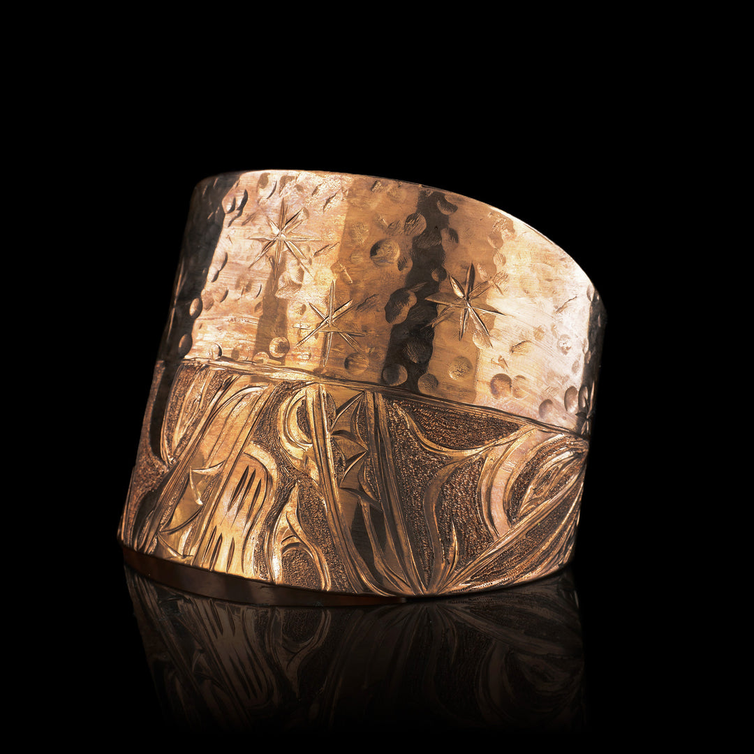 Hand-carved 2" Copper Wolf & Bear Tapered Bracelet by Kwakwaka'wakw artist Cristiano Bruno. This Indigenous statement cuff features masterful Northwest Coast formline engraving, hammered textures, and celestial star motifs.