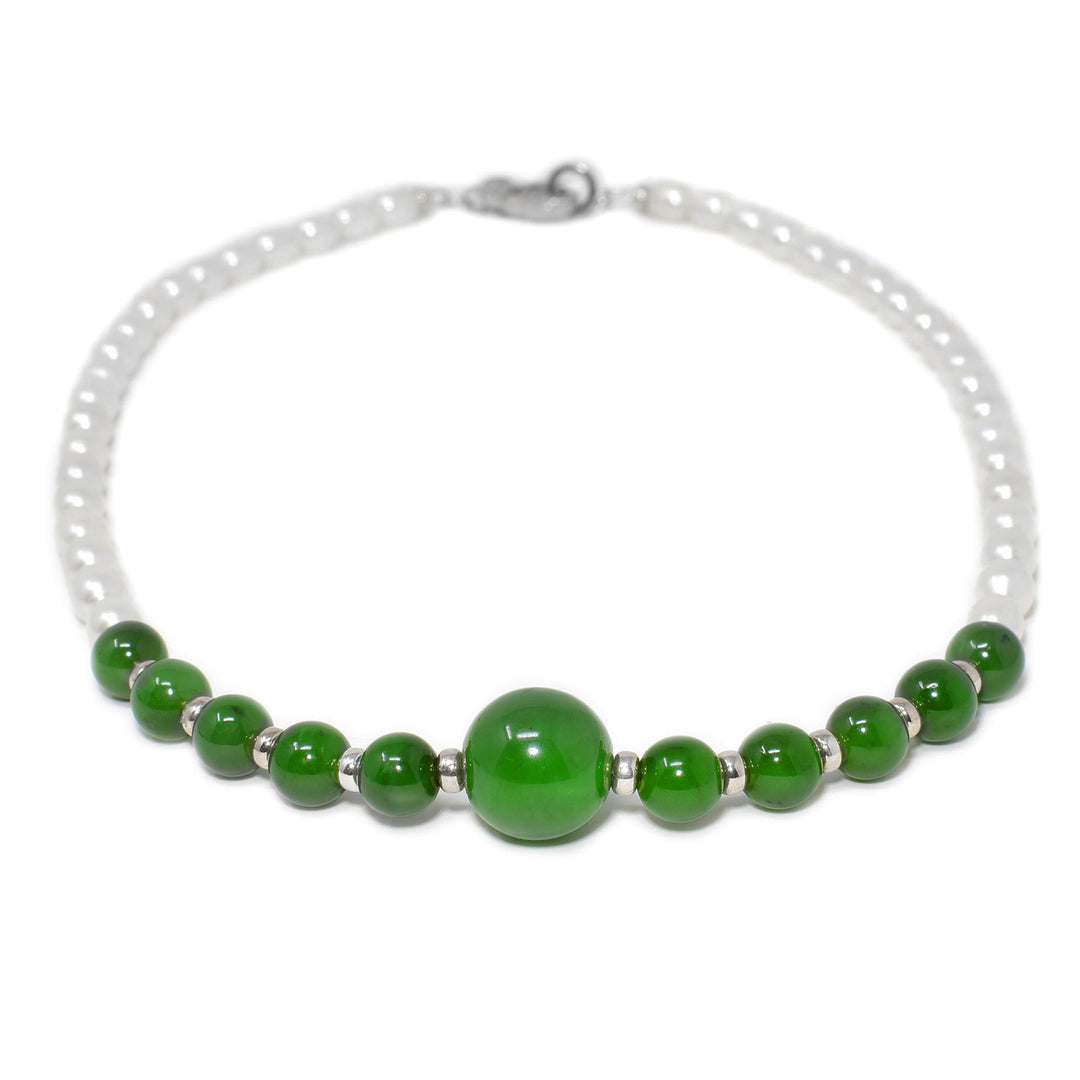 This jade necklace is made up of 10 small jade beads with a large bead as the center piece with sterling silver accents in between each. The rest of the necklace is white pearls.