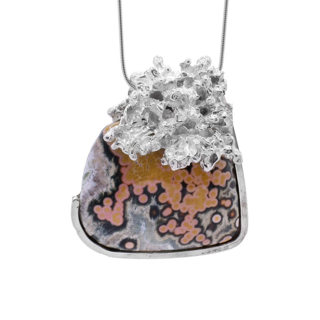 This ocean jasper necklace has a large, square-shaped ocean jasper as the centerpiece. On top is a unique, coral-like shaped sterling silver.