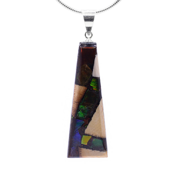 This unique ivory pendant is made from fossilized mammoth ivory, ammolite gemstone and sterling silver. The pendant is short, tapered, and wide and is made from casting the ivory and ammolite into the shape. The jump ring is made from sterling silver.