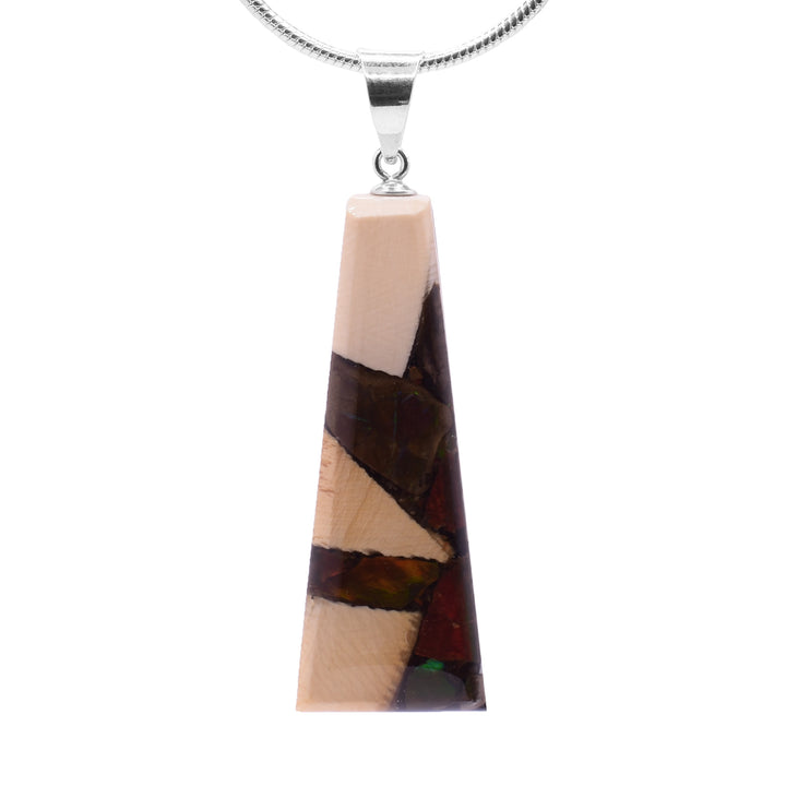 This unique ivory pendant is made from fossilized mammoth ivory, ammolite gemstone and sterling silver. The pendant is short, tapered, and wide and is made from casting the ivory and ammolite into the shape. The jump ring is made from sterling silver.
