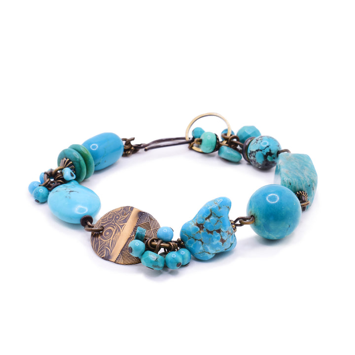 This bracelet speaks to Honica’s contemporary craftsmanship. From the custom hand worked brass to the carefully selected stones, this piece highlights the vivid contrast between Russian Amazonite’s minty softness and the classic brilliance of Turquoise and magnesite.