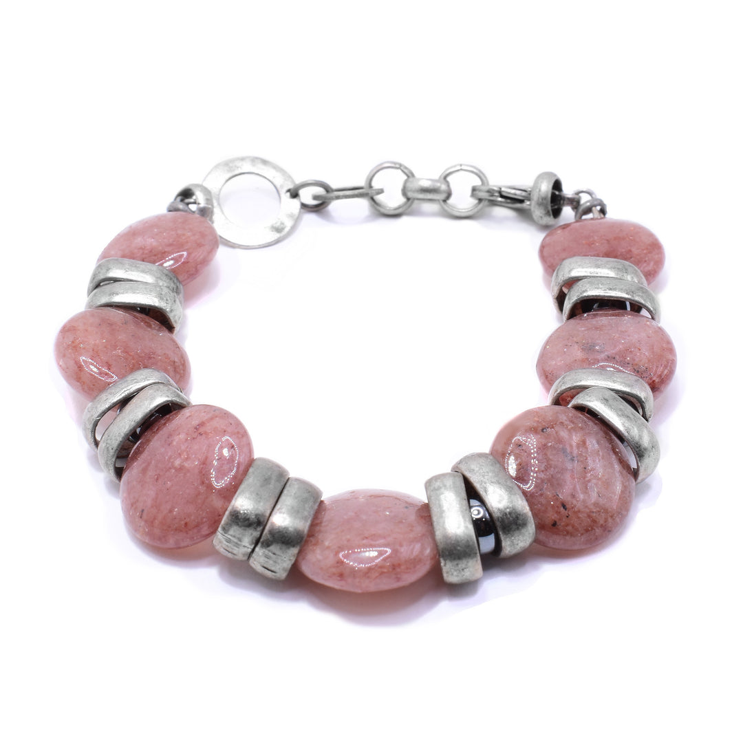 This gemstone bracelet features coin-shaped moscovite beads pink in colour with wide silver links separating them. The back has a link made from antique silver.