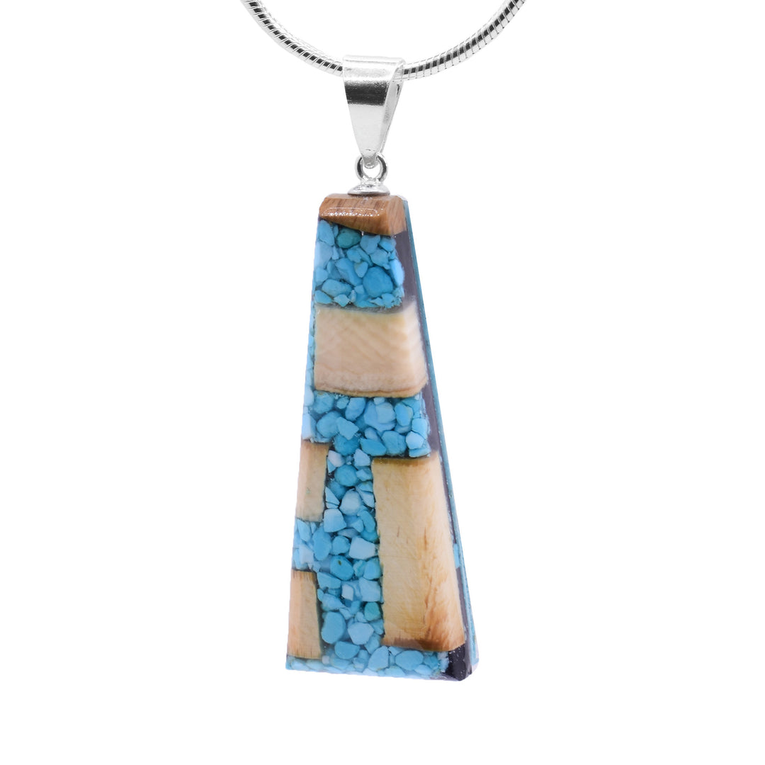 Turquoise and Mammoth Ivory Pendant by Aryn Bowers. Aryn uses fossilized mammoth ivory and pieces of turquoise to create the pendant before setting it on a sterling silver bail.