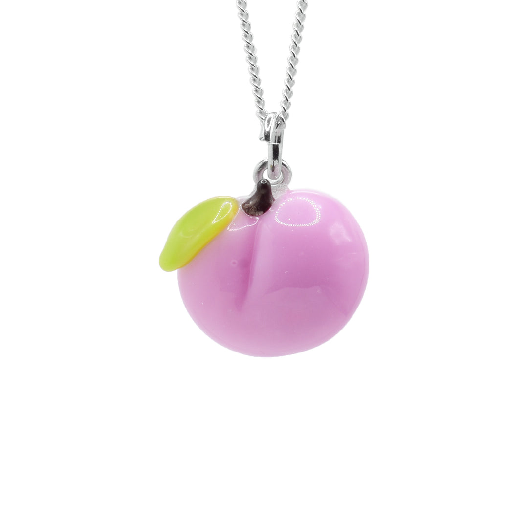This peach necklace has a pendant made from lamp worked glass. There is pink glass shaped like an oblong sphere and has a crease in the middle of it. There is a green leaf next to the brown stem at the top.