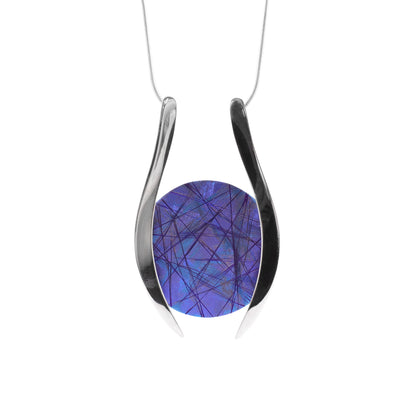 This titanium necklace has a circular piece of blue, purple titanium in the center with two large sterling silver accents on each side encasing it. The chain is attached to both the accents.