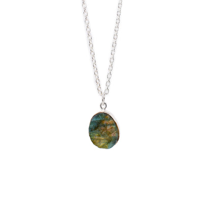 This necklace has a sterling silver chain. It has a big oval labradorite pendant in the middle. 