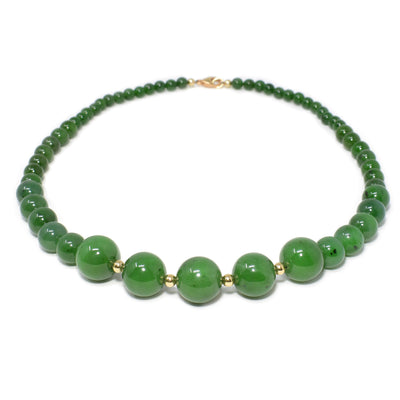 This jade necklace has 5 large jade beads with gold-filled accents in between in the front of the necklace and smaller beads making up the rest of the length.