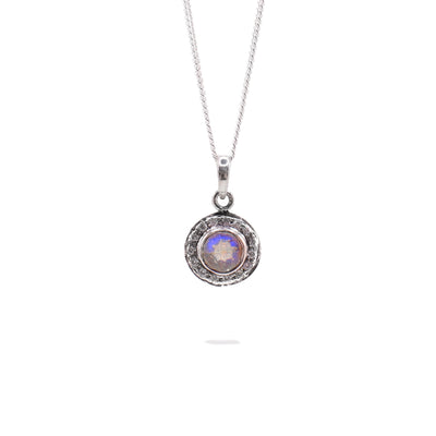 This necklace has a sterling silver chain with a round labradorite pendant encased in sterling silver.
