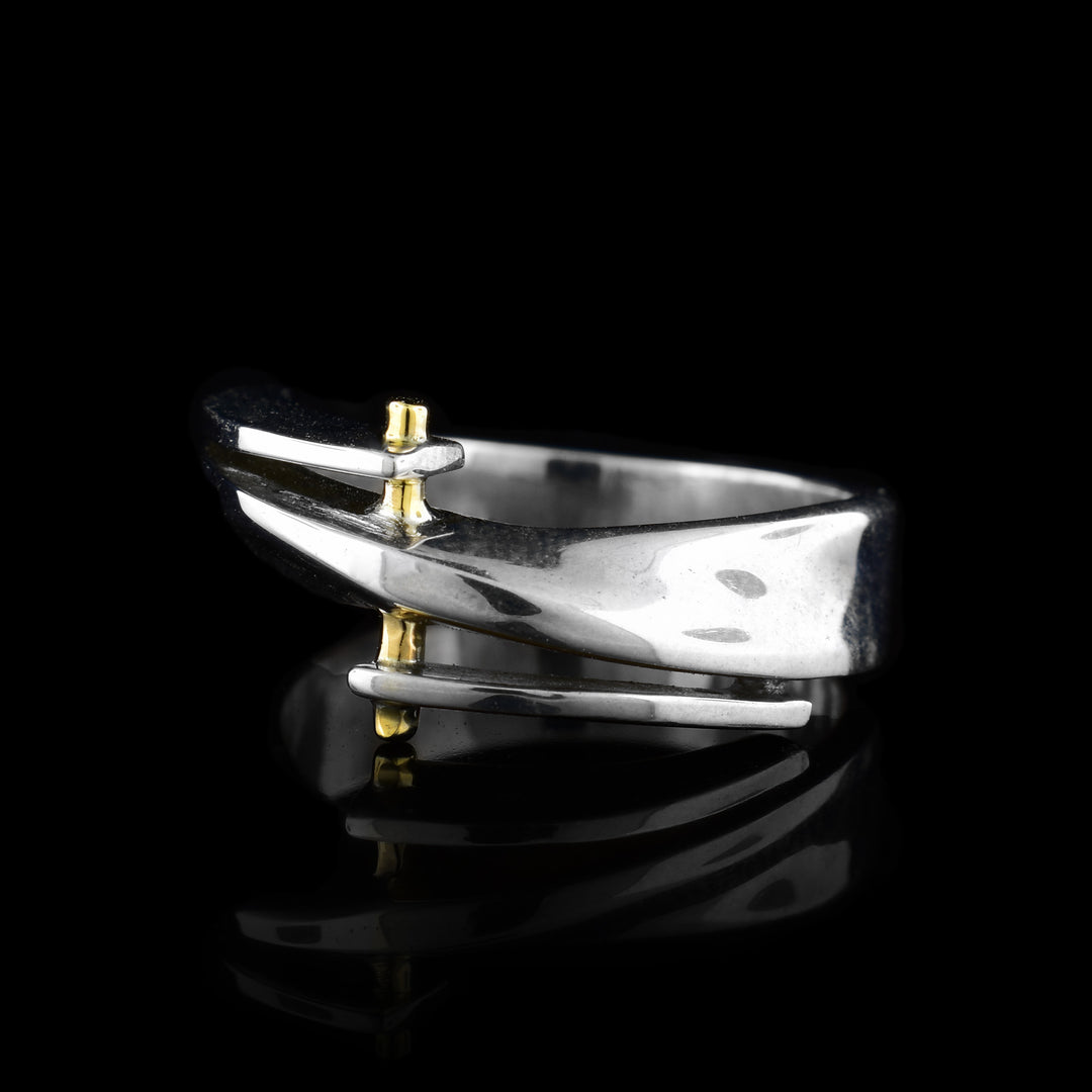 This gold and silver bypass ring three layers at the top of the ring with 14K gold embellishments on them.