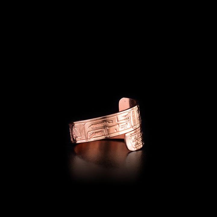 This copper ring has a thin band that wraps around the finger twice. There are depictions of the Wolf and the Orca carved into the surface of the band.