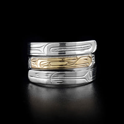 This wrap ring has three layers with the middle layer depicting the head of an eagle facing the right and made from gold. The rest of the ring is silver and has carvings depicting the bird's feathers.