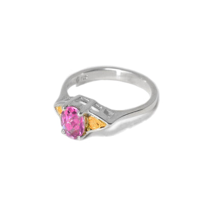 This pink topaz ring is oval in shape in the front with a round pink topaz in the center with 22k gold nugget accents on the sides.