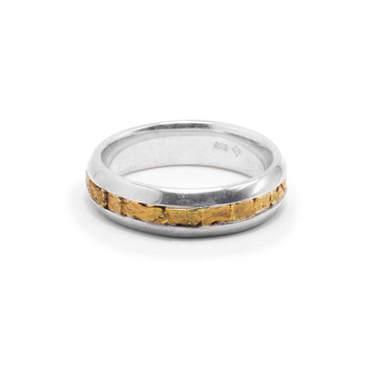 This mens gold nugget ring has a single, thin band that is made from sterling silver. In the center of the band, there are 22K gold nuggets around the whole piece.