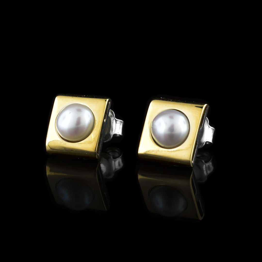 These pearl stud earrings are made from sterling silver and are square shaped. The top layer is made from 14K gold and has a freshwater pearl in the center of each earring.
