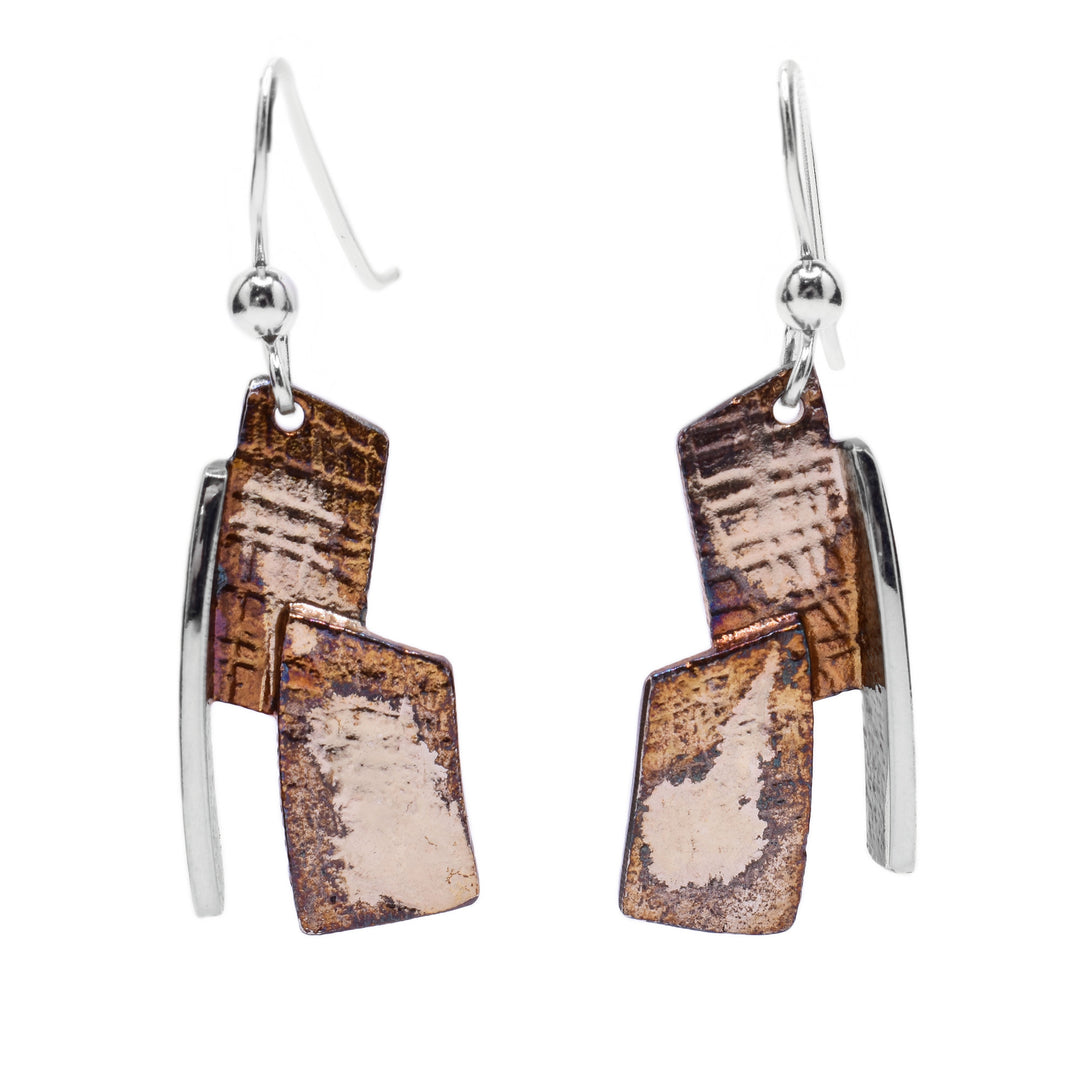 These oxidized silver earrings are made up of two rectangular pieces light brown and beige in colour stacked on top of each other with a linear sterling silver accent on the side.