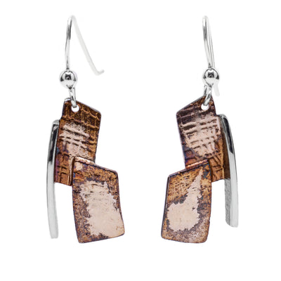 These oxidized silver earrings are made up of two rectangular pieces light brown and beige in colour stacked on top of each other with a linear sterling silver accent on the side.