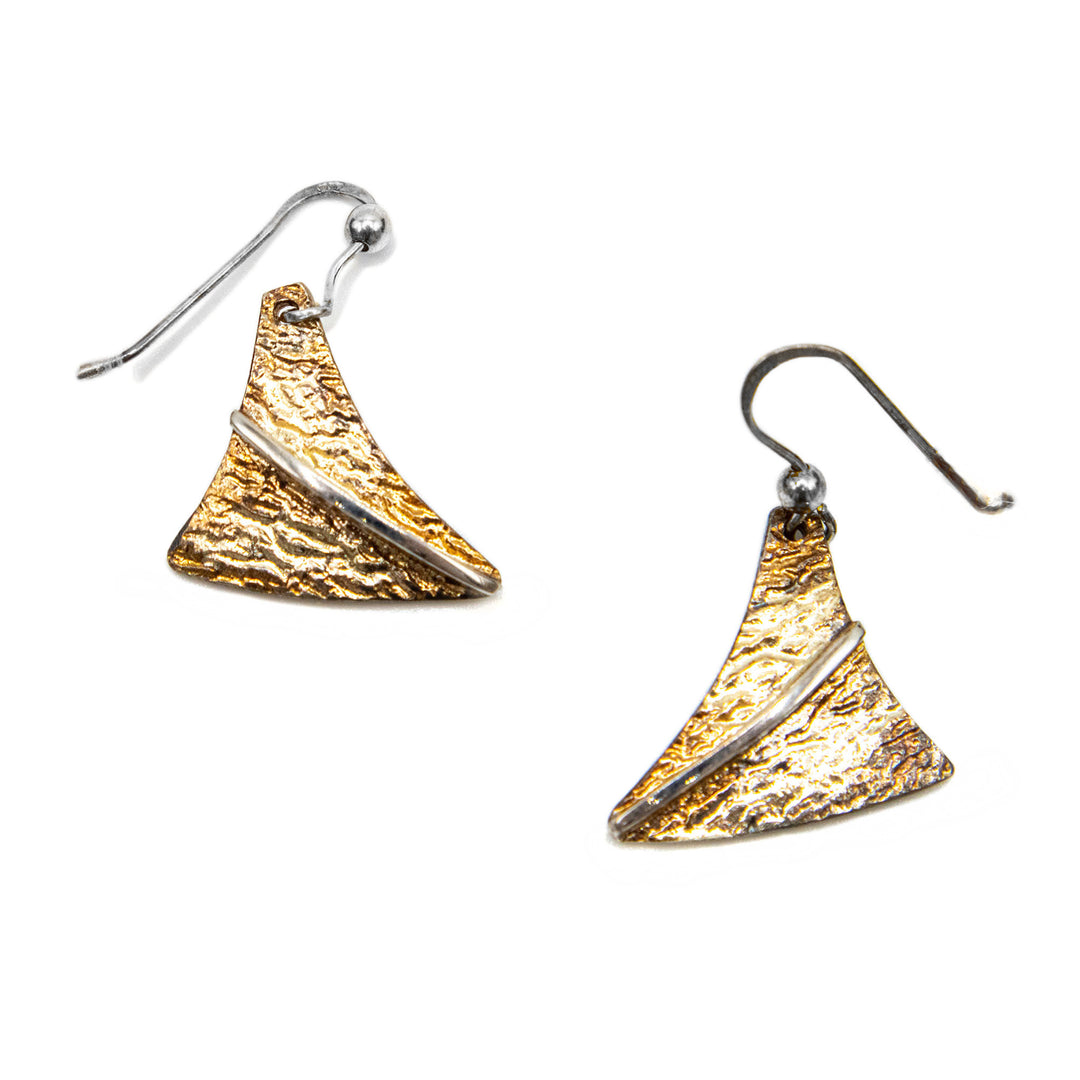 These oxidized silver earrings are made from oxidized sterling silver and 14K gold solder. The hangs are triangular with a rough texture and features 14K gold solder highlights giving the piece a brilliant color.