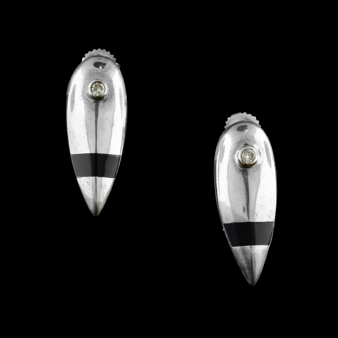 These sterling silver diamond earrings are shaped like long, inverted teardrops. At the top of the earring is a diamond wrapped in 14K gold and below that is a band of dark plexiglass.