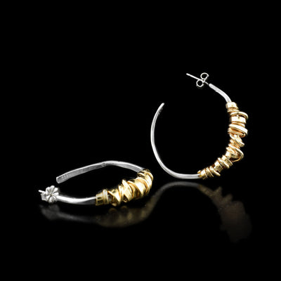 These hoop earrings are circular in shape and have a elegant design in which yellow gold-filled wire has been coiled around the front of each earring.