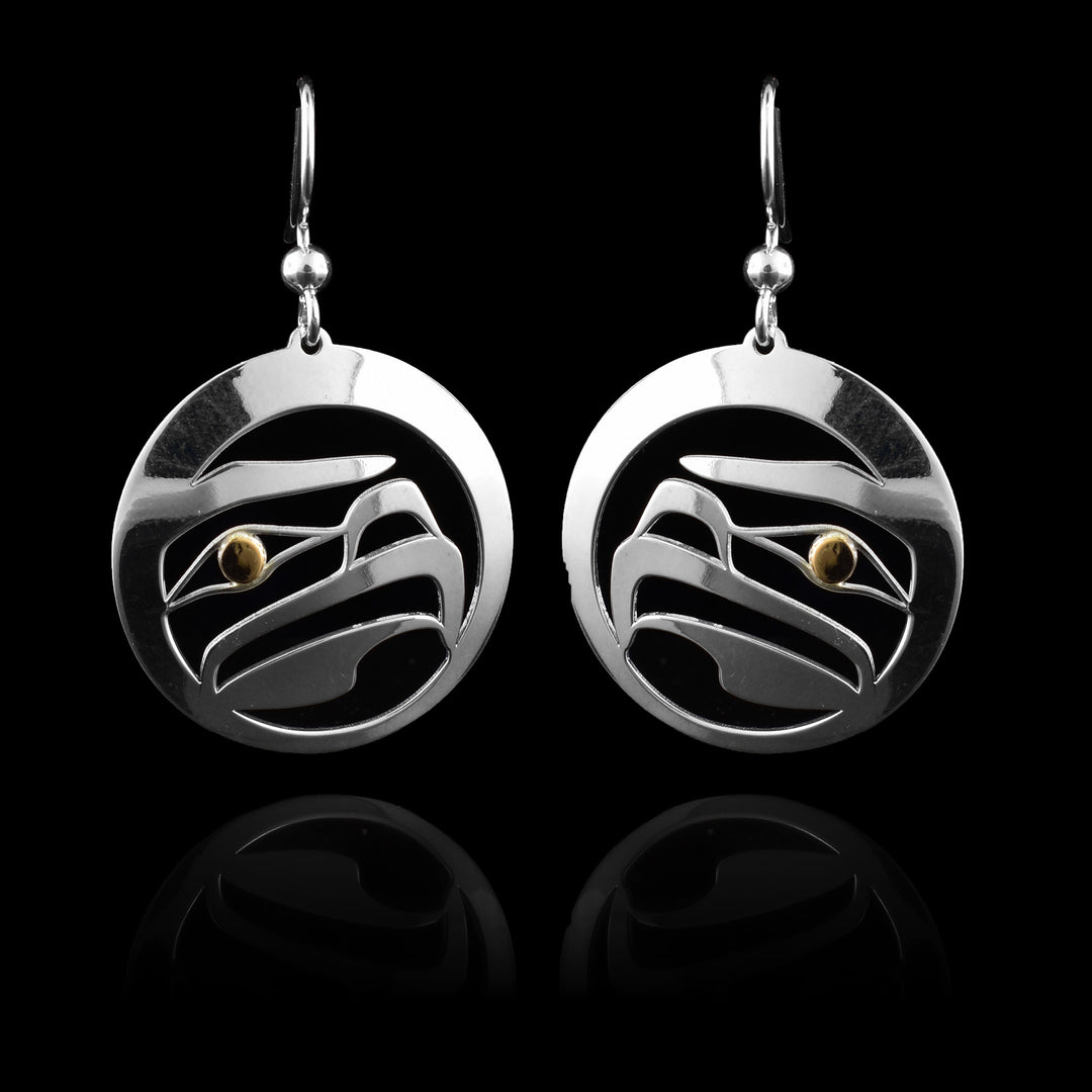 These dangling Eagle earrings are made from sterling silver and have circle shaped hangs. There are cutout designs made in the center of the hangs depicting the head of the Eagle. The eye of the legend is done in 14K gold.