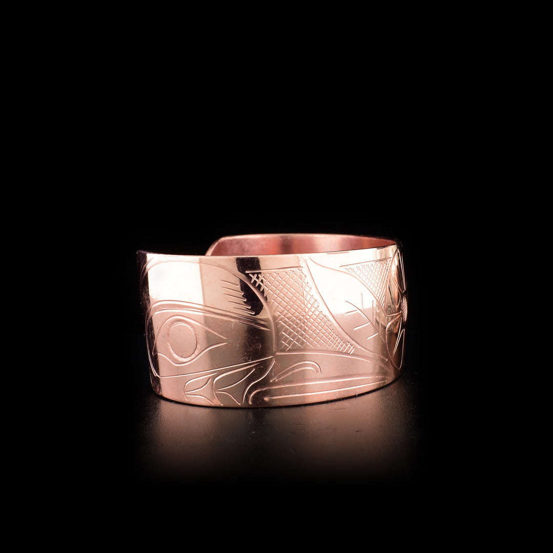 This Hummingbird bracelet is made from copper and has a wide band. There is a depiction of a flower carved into the center of the band, and there are two depictions of the Hummingbird carved into the corners of the brand.