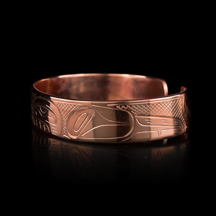 This Eagle and Orca bracelet cuff has a single, thing band with a gap in the back and is made using copper. There are depictions of the Eagle and the Orca that have been beautifully carved into the surface of the band.