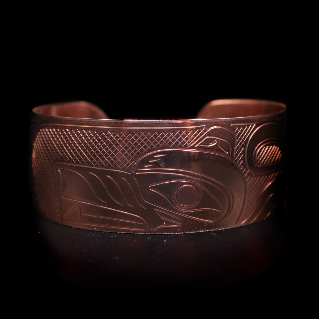 This wide cuff bracelet has a single copper band with a gap in the back. There is a full depiction of the Wolf legend carved across the surface of the band.