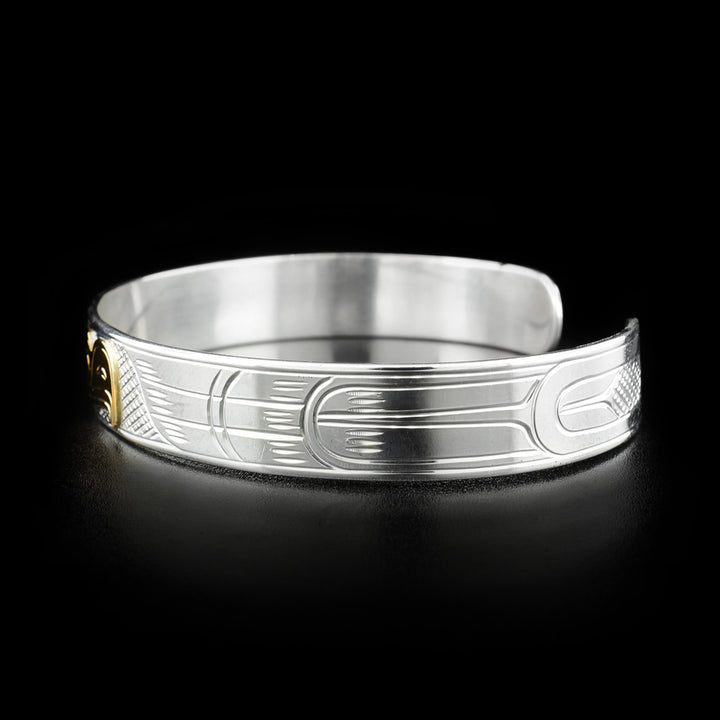 Right side photo of this silver bracelet has carvings depicting the wing and feathers of the eagle.
