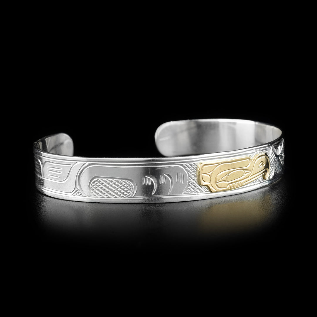 Side of bracelet featuring carved designs representing the wing of the eagle and its feathers.