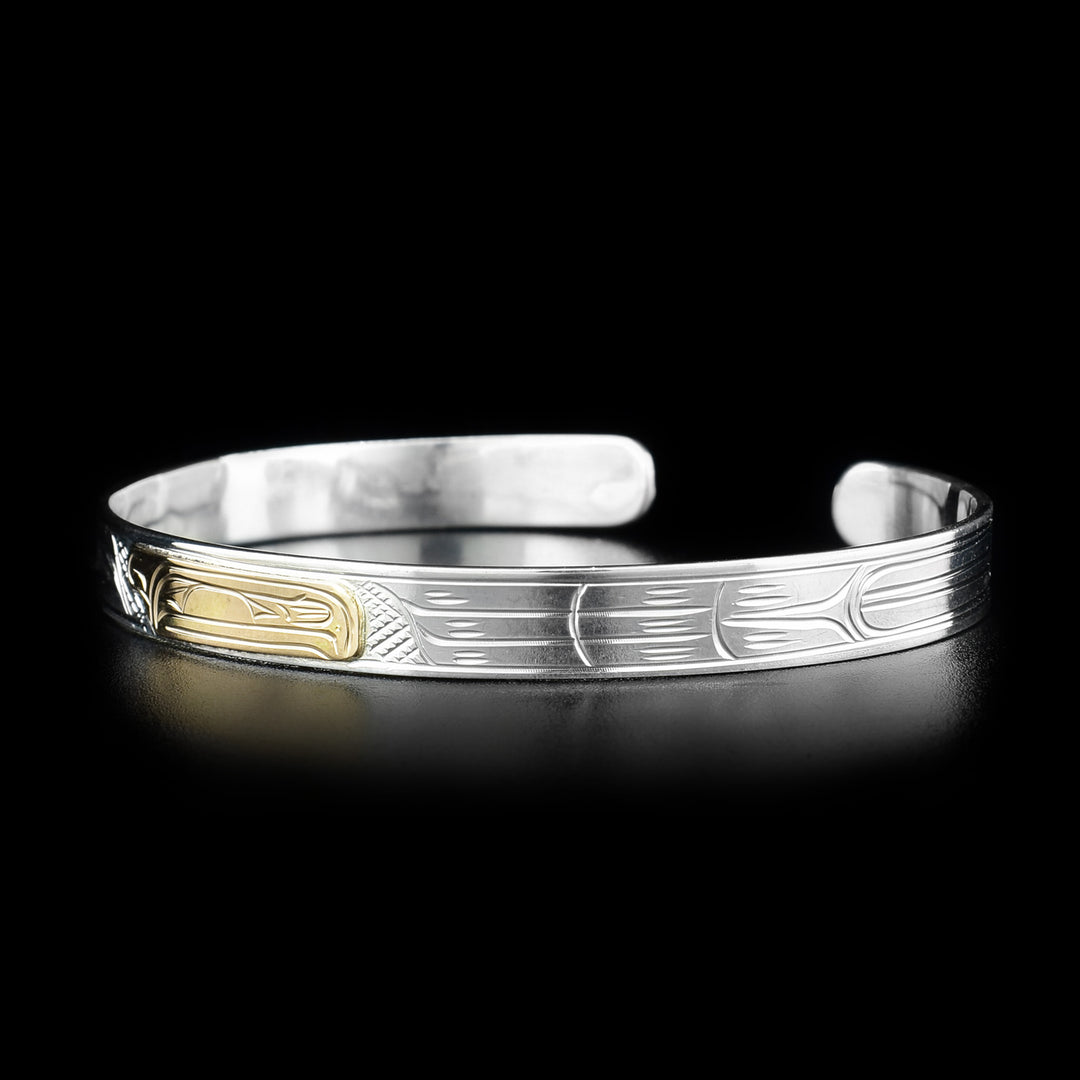 Right side photo of the raven bracelet shows carvings depicting more feathers belonging to the raven.