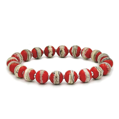 This glass bead bracelet has 20 beads connected on an elastic cord. Each bead is a mixture of red and white with grey lines.