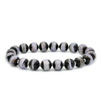 This glass bead bracelet has 20 beads connected on an elastic cord. Each bead is a mixture of black, grey, and light purple.