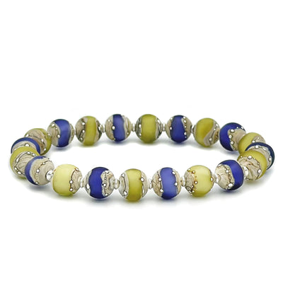 This glass bead bracelet has 20 beads connected on an elastic cord. The beads are alternating in colours between blue and yellow with scattered white dots.