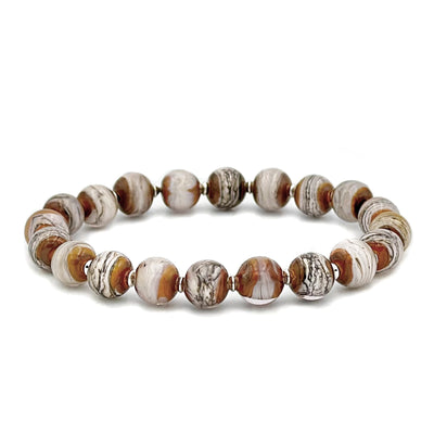 This glass bead bracelet has 20 beads connected on an elastic cord. Each bead is a mixture of beige and white with grey lines.