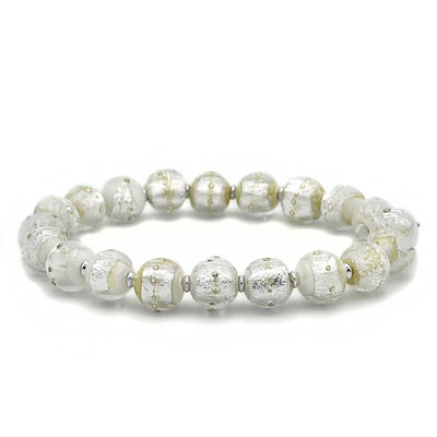 This glass bead bracelet has 20 beads connected on an elastic cord. Each bead is a mixture of shiny silver, white, and yellow with scattered white dots.