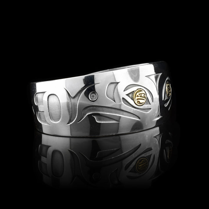 This gorgeous Eagle bracelet is made from sterling silver, 14K gold and has a slightly tapered, wide band with a gap in the back. There are cutout designs depicting two Eagles and there eyes are made from gold and also depict Eagles.