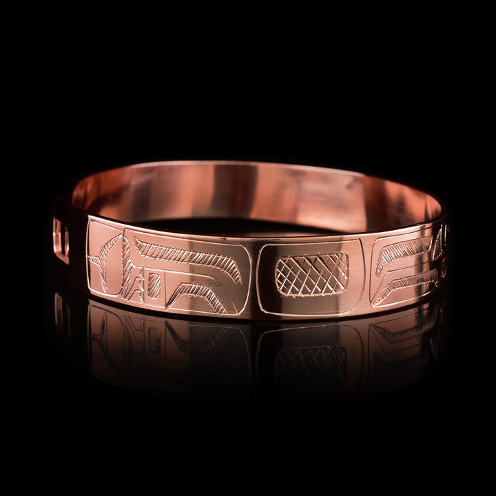 This Wolf bracelet is made from copper and has a single, thin band with a simple hook clasp in the back of it. There is a depiction of the Wolf that has been carved into the surface of the band.