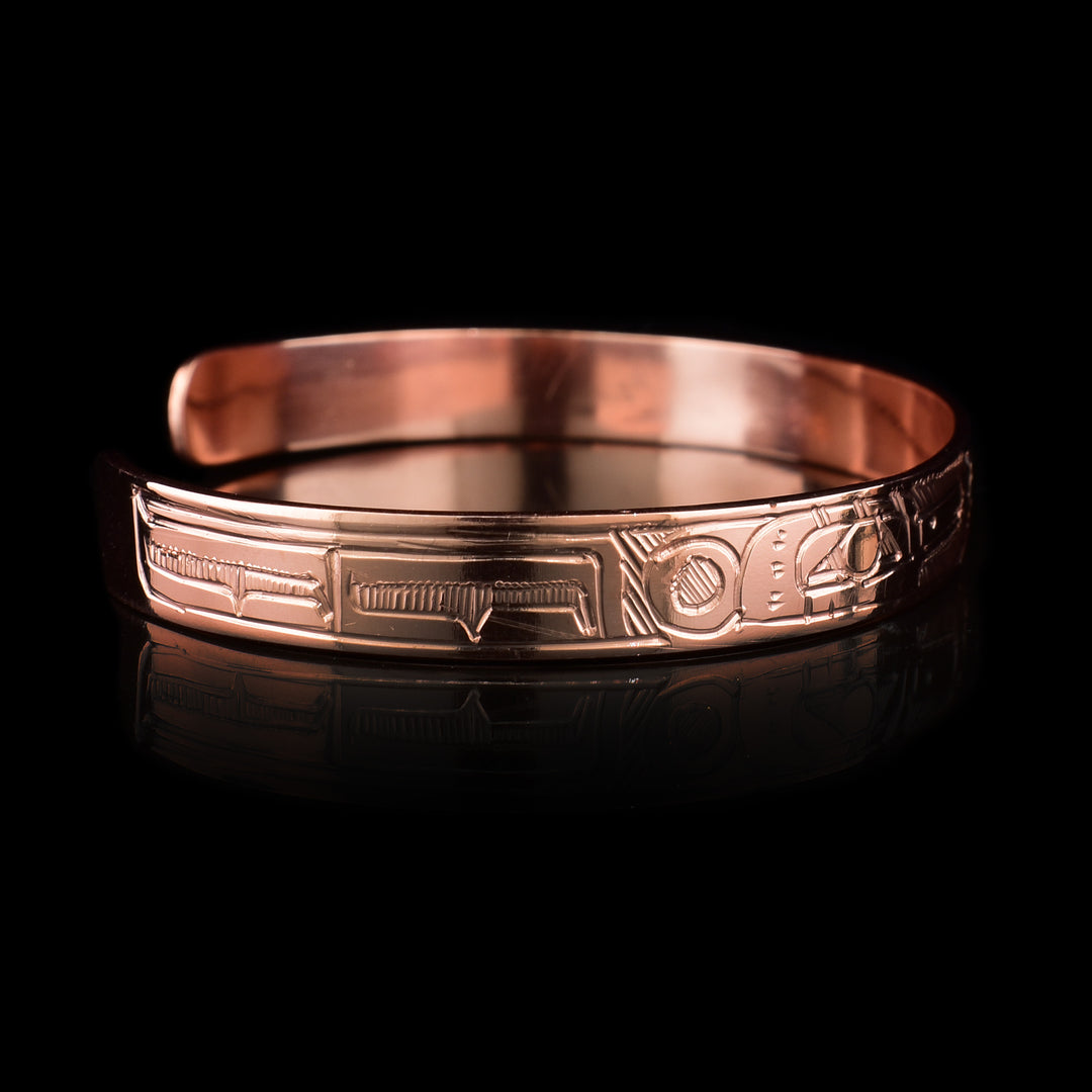 This Sun and Hummingbird bracelet is made using copper and has a thin band with a gap in the back. There are two depictions of the Hummingbird facing each other with the Sun depicted in the center of the legends that have been carved into the surface of the band. The legends meet at the top of the band.